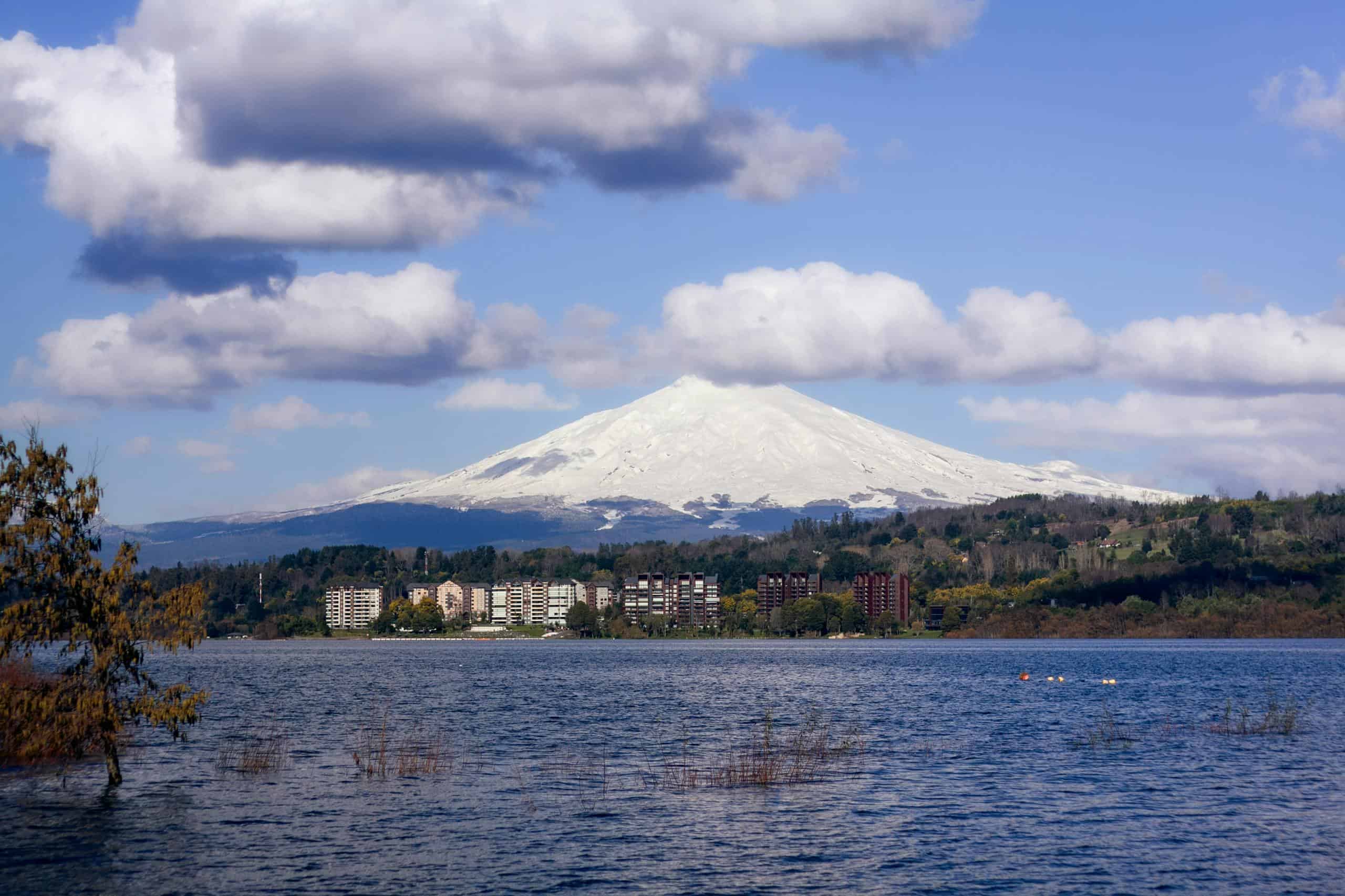 Scenic view of snowcapped Villarrica Volcano over lake in Araucanía, Chile.