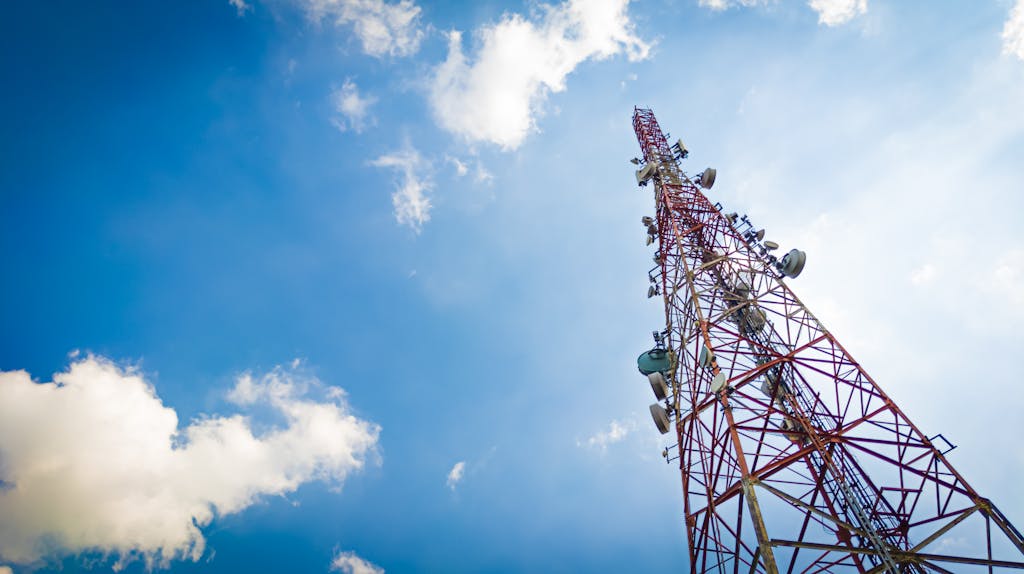 View of a tall telecom tower set against a clear blue sky.
