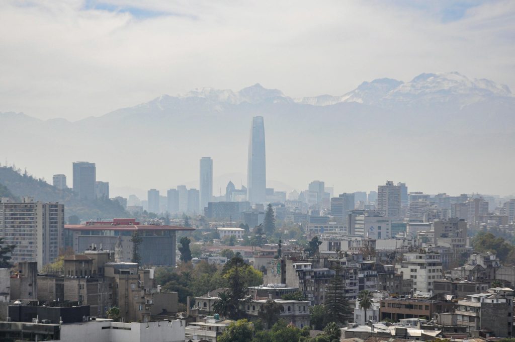 Panoramic view of Santiago's skyline with Andes mountains in the background.