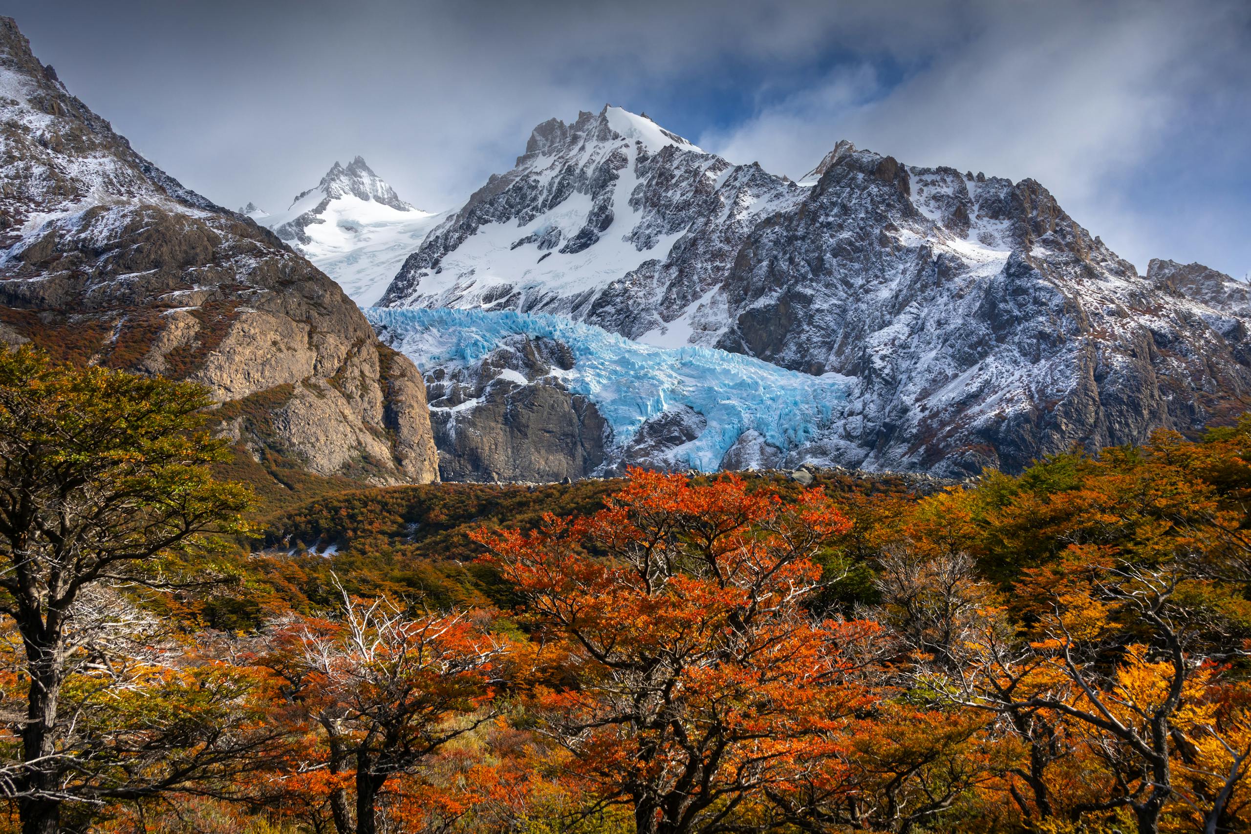 Stunning view of snow-capped mountains and colorful fall foliage in Patagonia.