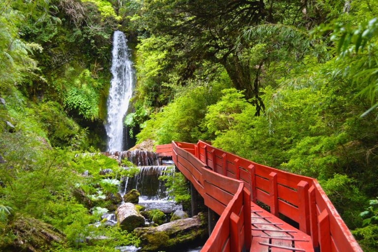 Landscape photo of waterfall and red walkway at former Termas Geometricas